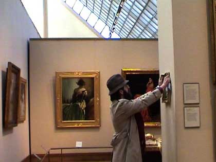 Banksy surreptitiously hanging his work in the Met