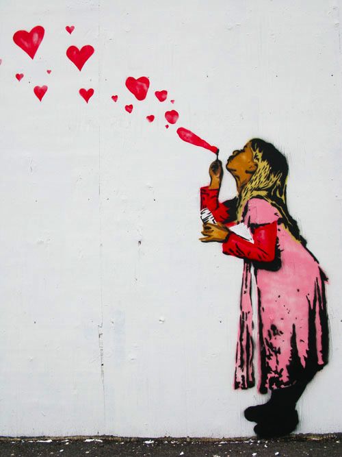 graffiti -- girl blowing heart-bubbles up to the sky